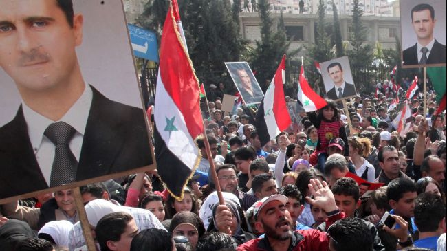 Photo of Syrians hold rallies in support of President Assad