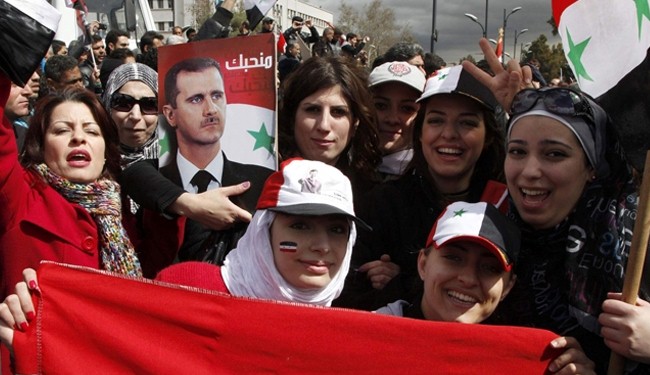 Photo of Syrians stage pro-government rally made the mad dog enemies of Syria crazy