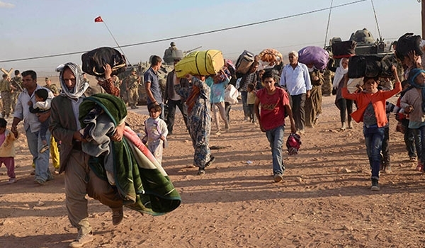 Photo of Turkish Security Troops Clash with Fleeing Syrian Kurd Refugees